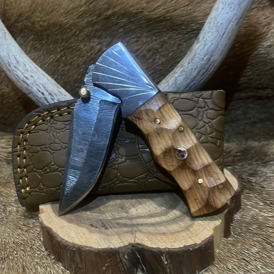 Damascus flipper with brass thumb catch and holster